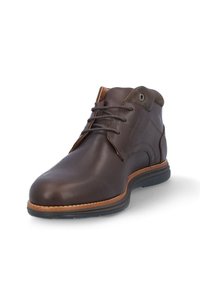 Botas de tobillo de cuero marrón con un acabado suave, que presentan una puntera redondeada y una suela en contraste color beige, acentuadas por un diseño de cordones y detalles de costura.