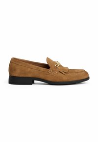 Brown suede loafers with a low black heel, featuring a decorative fringe and metallic accent on the front.