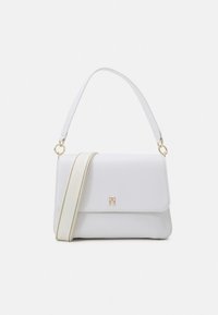 White leather handbag with a structured design, featuring a gold-tone logo accent and a detachable adjustable shoulder strap.