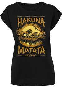 Camiseta de algodón negra con un diseño gráfico amarillo que incluye el texto "Hakuna Matata" e ilustraciones de leones de El Rey León de Disney.