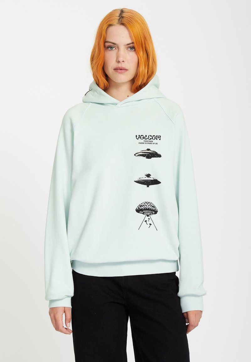 Mintgrön hoodie med avslappnad passform, prydd med svarta UFO-grafik och text på framsidan. Tillverkad av mjukt material med ribbade muddar.