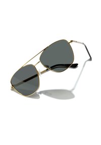 Ochelari de soare aviator din metal auriu cu lentile gri închise, având un design cu pod dublu și brațe negre. Pernele nazale transparente asigură confortul.