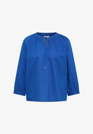 Blouse bleu vif à manches longues avec encolure froncée, ouverture goutte d'eau et cordon avec embouts métalliques, coupe ample et poignets élastiqués.