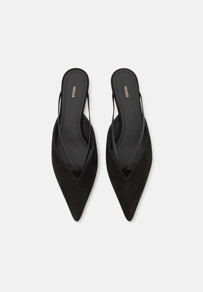 Schwarze Wildleder Slingback-Schuhe mit spitzem Absatz und dünnen Riemen in einem eleganten Design. Glatte Textur und minimalistischer Stil. Markenname auf der Innensohle.