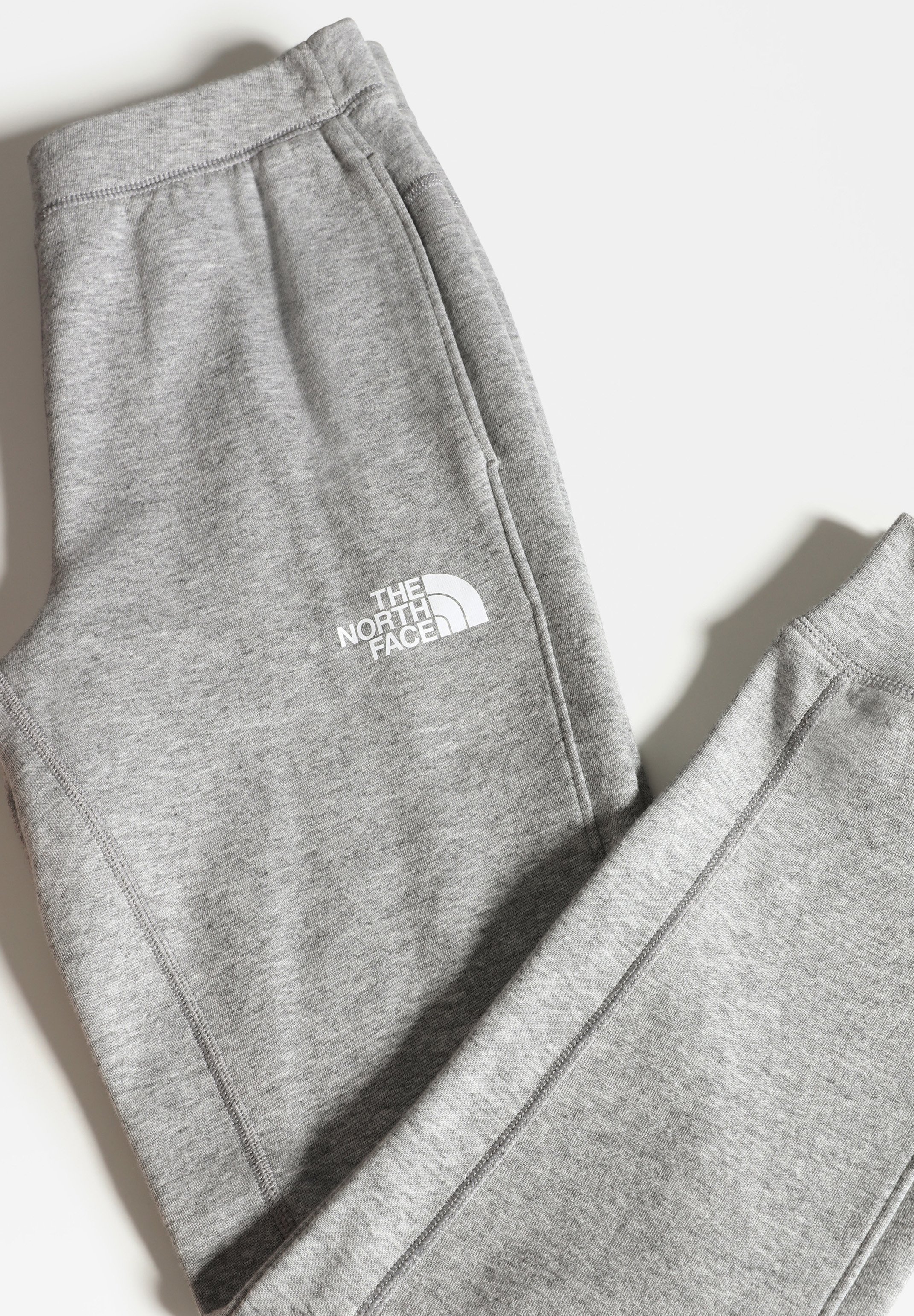grey and black north face tracksuit