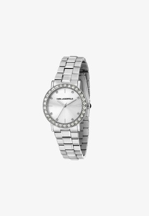 Orologio in metallo argentato con quadrante rotondo, dial bianco e dettagli in cristallo sulla lunetta. Presenta un design a bracciale a maglie con finitura lucida.