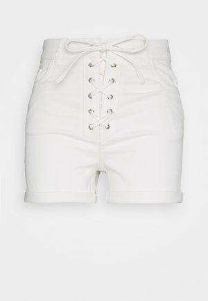 White denim shorts with a high waist, featuring a lace-up front with silver eyelets, rolled cuffs, and two side pockets.