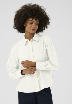 White button-up shirt with a structured collar and long sleeves, featuring a decorative button placket detail. Smooth cotton fabric, regular fit.