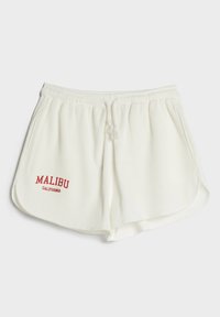 Bílé žebrované kraťasy s elastickým pasem a nastavitelným šňůrkovým mediálníkem, na přední straně s červenou výšivkou "MALIBU CALIFORNIA".