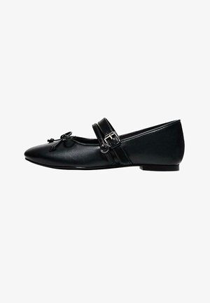 Black pointed-toe Mary Jane flat shoe with double straps, silver buckle, and small decorative bow on front.