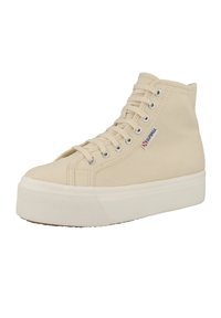 High-top sneakers in cream canvas with a textured rubber platform sole. Features metal eyelets and branded logo detail on the side.
