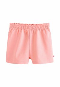 Shorts en coton à taille élastique rose clair avec une petite étiquette en forme de cœur sur le côté, posés à plat sur un fond blanc.