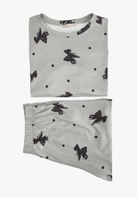 Lys grå stoftop og nederdel med sort sløjfe og prikmønster. Glat tekstur med rund halsudskæring og elastisk talje.