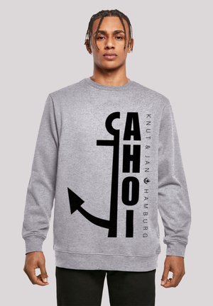 Gray sweatshirt featuring bold black text and an anchor graphic, made of a soft fabric with ribbed cuffs and hem.