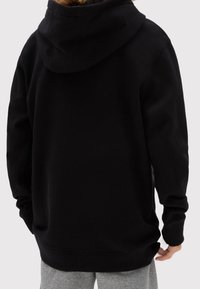 Felpa nera con cappuccio, dal fit rilassato, maniche e orlo a coste. Realizzata in tessuto morbido, presenta una tasca a marsupio e un branding minimale.