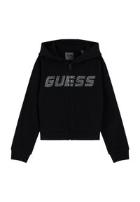 Haut à zip noir en tissu doux, avec capuche, poignets côtelés et un logo argenté scintillant "GUESS" sur la poitrine.