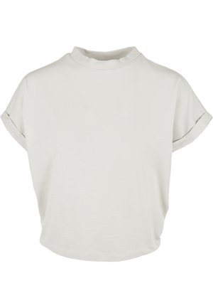 Lichtbeige overhemd met korte mouwen, een hoge kraag, zachte katoenen textuur, losse pasvorm en opgerolde manchetten. Glad, minimalistisch ontwerp.