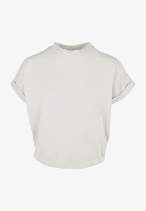 Lichtbeige overhemd met korte mouwen, een hoge kraag, zachte katoenen textuur, losse pasvorm en opgerolde manchetten. Glad, minimalistisch ontwerp.