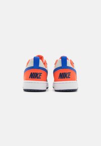 Nike sneakers with a predominantly orange and blue color scheme, featuring a gray heel, durable material, and rubber sole. Large logo on back.