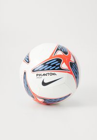 Balts futbola bumbas ar ziliem un sarkaniem ģeometriskiem rakstiem. Uz balona melnā krāsā izdrukāts teksts "PHANTOM PITCH" un Nike logo. Tekstūrēta virsma, sfēriska forma.