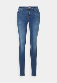 Jeans skinny feitos de denim de peso médio na cor azul escuro, com cinco bolsos, passantes para cinto e um desbotado leve na frente.