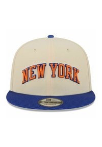 Cream baseball cap with blue flat brim and "NEW YORK" embroidered in orange. Features textured brim and a snapback adjustable closure.