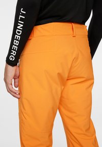 J.LINDEBERG Sports CLARKE - Pantaloni da sci - persimmon orange