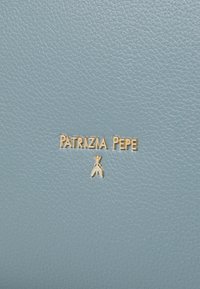 Light blue leather material featuring a textured finish. Gold embossed logo "PATRYZIA PEPE" and a small emblem below.