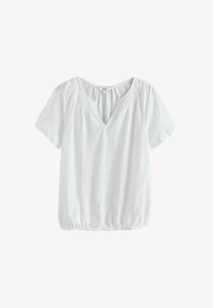 Balta trumpomis rankovėmis palaidinė su V formos iškirpte, surinkta raukiniais prie iškirptės ir elastine apačia. Pagaminta iš lengvos tekstūruotos medžiagos.