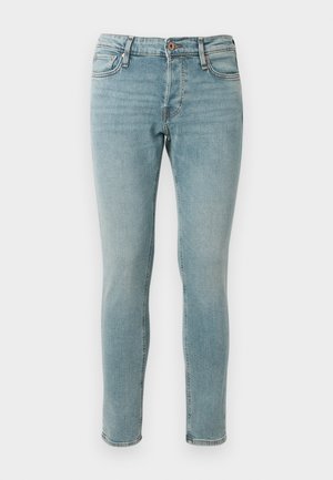Light blue skinny jeans made of denim, featuring a classic five-pocket design, a button and zipper fly, and subtle fading details.