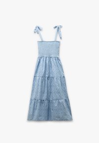 Vestido de tirantes azul claro con cuerpo fruncido, tirantes ajustables y tela estampada que presenta formas de diamante y pequeños recortes.