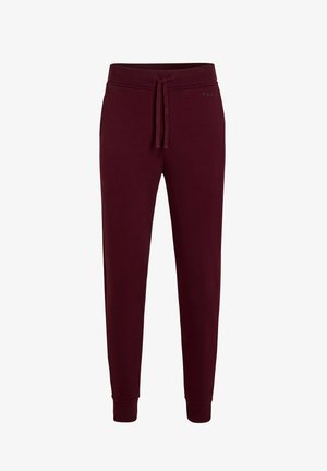 Bordeaux sweatpants met een trekkoord in de taille, taps toelopende pijpen, ribgebreide boorden en een gladde textuur. Subtiele branding aan de zijkant.