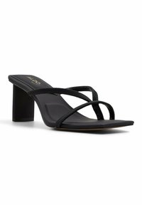 Black heeled sandals with a square toe, featuring crisscross textile straps and a block heel, designed for stability and comfort.