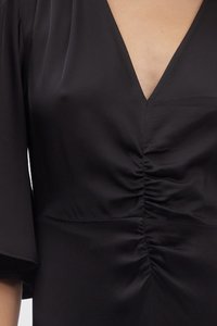 Black blouse featuring a deep V-neck, short sleeves, and gathered detailing at the waist. Smooth, lightweight fabric with a subtle sheen.