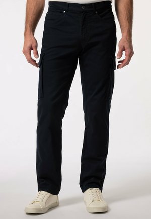 Navy cargo pants made of cotton with side pockets, a straight cut, and a button closure. Worn with white sneakers.