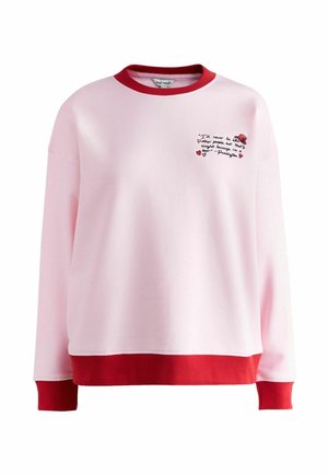 Light pink sweatshirt with red collar, cuffs, and hem, featuring small embroidered text and a red hat graphic on the chest.