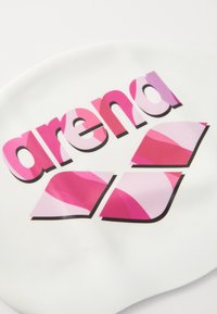 Objet ovale blanc avec le mot "sont" en rose vif en gras et "nd" dans un dégradé de teintes roses, avec deux accents géométriques roses en dessous.