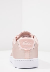 Pink satin sneaker with a textured white rubber sole. Features a branded back logo and padded collar for comfort.