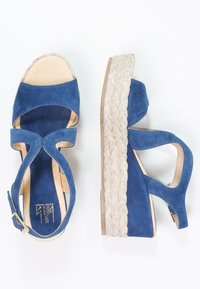 Sandali platform blu in suede con zeppa in juta intrecciata, punta aperta e cinturino alla caviglia con fibbia dorata. Interno liscio.