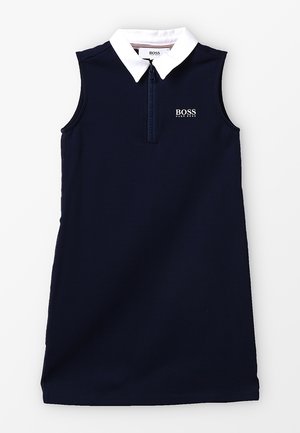 Vestido tipo polo sin mangas de color azul marino con un cuello blanco, cremallera frontal de medio cierre y el logo bordado "BOSS" en el pecho. Textura de tela suave.