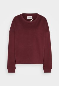 Sweat-shirt manches longues col rond en bordeaux foncé avec poignets côtelés et ourlet légèrement raccourci.