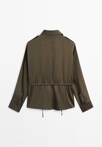 Olive green, long-sleeve shirt with a collar, cinched waist, and buttoned cuffs. Smooth texture with a subtle sheen and adjustable drawstring.