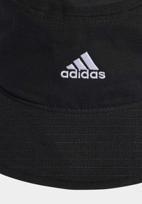 Cappello a secchiello nero realizzato in tessuto testurizzato, con una ampia visiera e un logo Adidas ricamato in bianco sulla parte anteriore.