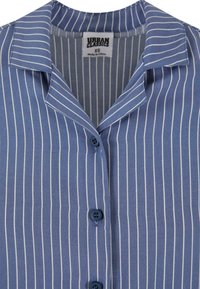 Button-up shirt in light blue fabric with white vertical stripes, featuring a collar, short sleeves, and dark blue buttons. Size XS.