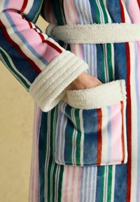 Striped fleece robe in pink, blue, and green with a plush white collar and cuff, featuring side pockets lined with soft fabric.