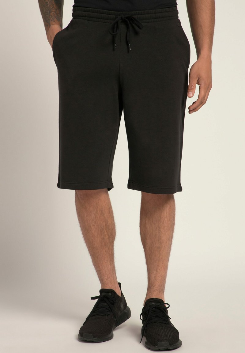 Shorts de sport noirs en mélange de coton doux. Dotés d'une taille élastique avec cordon de serrage ajustable et de poches latérales.