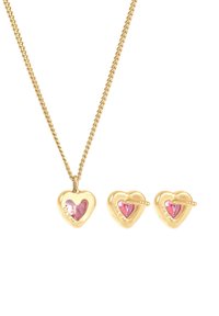 Hjärformad halskedja och örhängen i guldton med rosa ädelstenar. Har en texturerad kedja och säkra stängningar. Storlek och detaljer varierar.