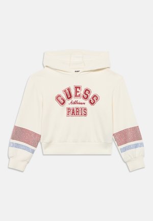 Sudadera blanca recortada con detalles en rojo y azul, con el gráfico "GUESS Athletics Paris". Hecha de un material suave con mangas texturizadas.