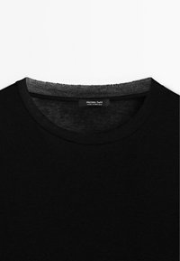 Black cotton t-shirt with a round neck. Features a gray ribbed neckline and a label that reads "Massimo Dutti, made in Portugal."