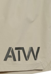 Beżowa tkanina z czarnymi stylizowanymi literami "ATW" nadrukowanymi blisko brzegu z widocznym przeszyciem na krawędzi.